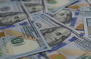 Multiple U.S. dollar bills scattered, representing wealth, financial matters, and legal services related to money management.